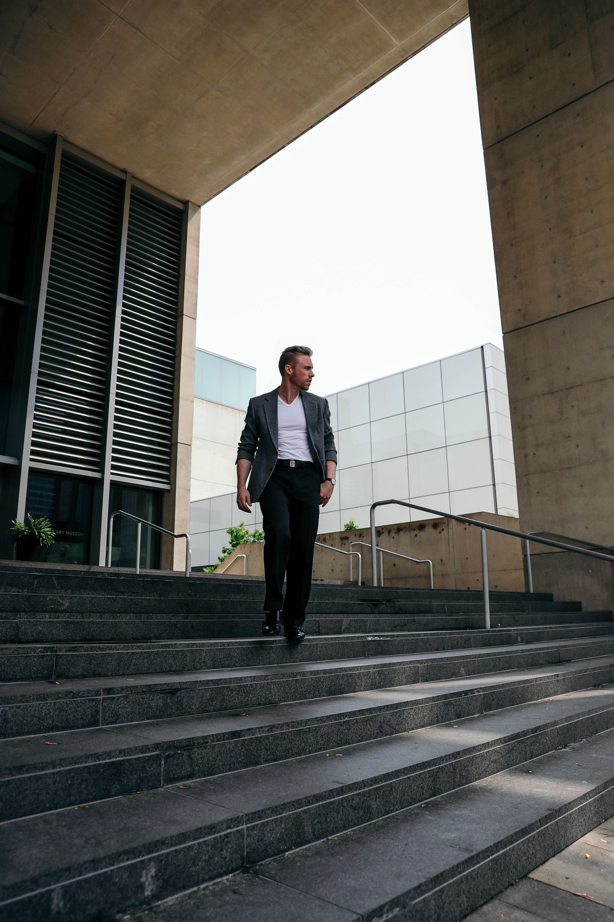 Person standing on steps outside a modern building